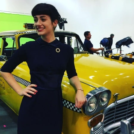 Holly Curran is posing for a photo on the set of Save Heart.